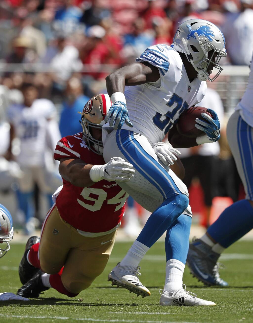 Detroit Lions running back Kerryon Johnson, right, runs with the ball against San Francisco 49ers defensive end Solomon Thomas during the first half in Santa Clara, Sunday, Sept. 16, 2018. (AP Photo/Tony Avelar)