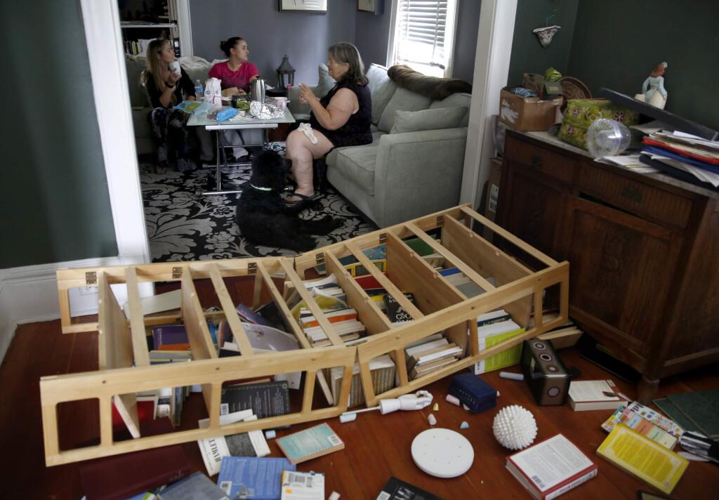 Resident Linda Landels, right, eats breakfast with friends Amanda Ardizzone and Jessica Ardizzone in her home after a 6.0 earthquake in on Sunday, August 24, 2014 in Napa, California. (BETH SCHLANKER/ The Press Democrat)