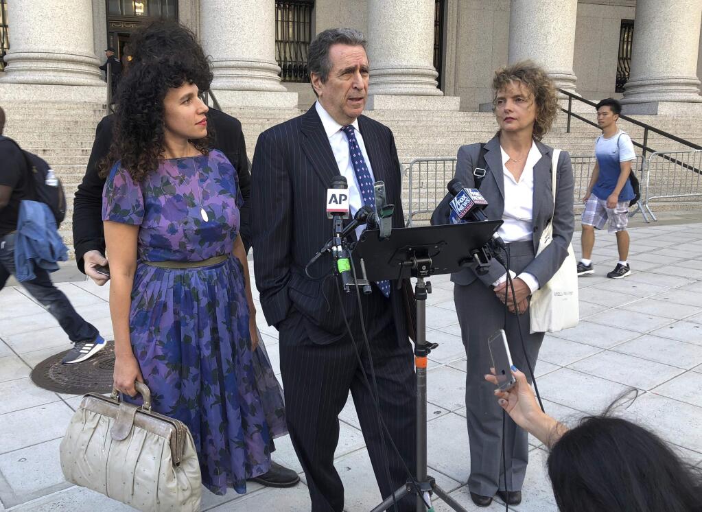 From left, Kristine Rakowsky, civil rights lawyer Norman Siegel,and Liane Nikitovich, meet with reporters outside federal court in New York on Wednesday, Oct. 3, 2018. The women filed a lawsuit arguing they should not be compelled to receive emergency alerts from the government on their phones. (AP Photo/Ted Shaffrey)