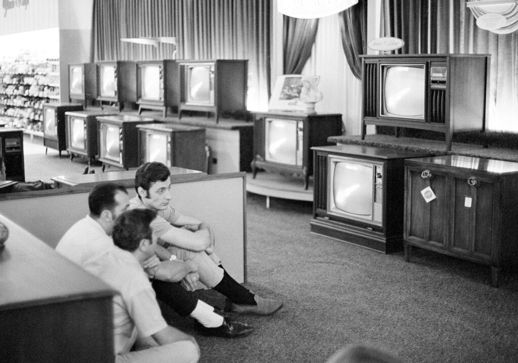 People watch the Apollo 11 moon launch on multiple TV sets at a Sears department store in White Plains, New York in 1969. Sears once dominated the American landscape. (RON FREHM / Associated Press, 1969)