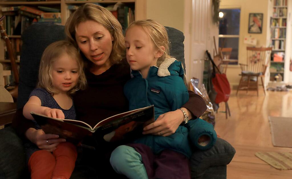 Sonoma County Supervisor Lynda Hopkins pregnant with her third child, spends reading time with her two girls Adeline, 3, left, and Gillian, 6, Wednesday Jan. 9, 2019 in Forestville. (Kent Porter / The Press Democrat) 2019