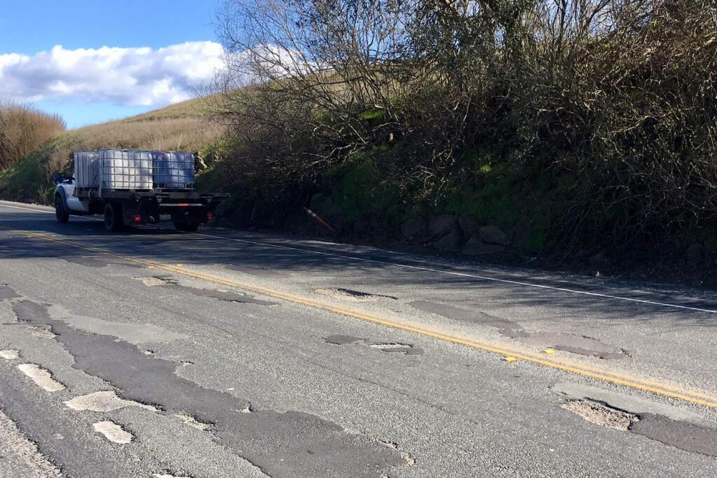 Potholes patched and unpatched on Adobe Rd., Sonoma County. (Lorna Sheridan)
