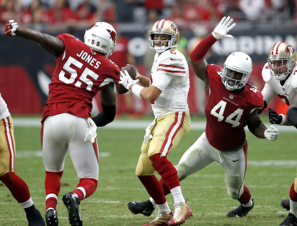 San Francisco 49ers quarterback Brian Hoyer looks to throw as Arizona Cardinals outside linebacker Markus Golden (44) and outside linebacker Chandler Jones (55) pursue during the second half Sunday, Oct. 1, 2017, in Glendale, Ariz. (AP Photo/Ross D. Franklin)