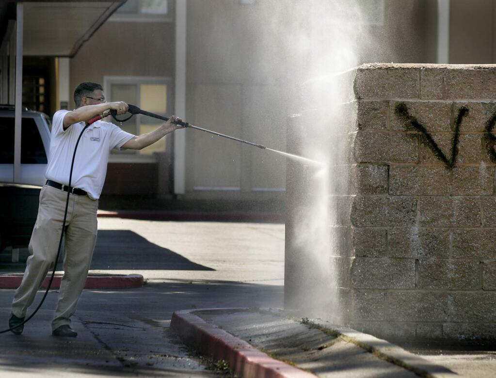 (File photo) Glenn Schoeneck, the community manager of Sonoma Ridge apartment homes in Santa Rosa power washes gang graffiti, Wednesday April 22, 2009 at the complex. Schoeneck is also a volunteer for the Santa Rosa graffiti abatement program. (Kent Porter / The Press Democrat)2009