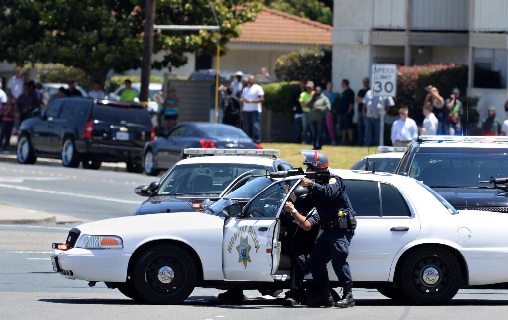 Law enforcement work a hostage situation in Antioch, Calif., Wednesday, May 27, 2015. A carjacker surrendered peacefully Wednesday after releasing two hostages who were held in a tense standoff with police at a convenience store in Northern California, authorities said. (Susan Tripp Pollard/The Contra Costa Times-Bay Area News Group via AP) MANDATORY CREDIT