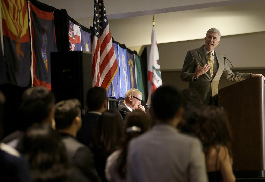 Associate Supreme Court Justice Neil Gorsuch, top, speaks to new U.S. citizens during a naturalization ceremony at the Ninth Circuit courts' judicial conference in San Francisco, Monday, July 17, 2017. (AP Photo/Jeff Chiu)