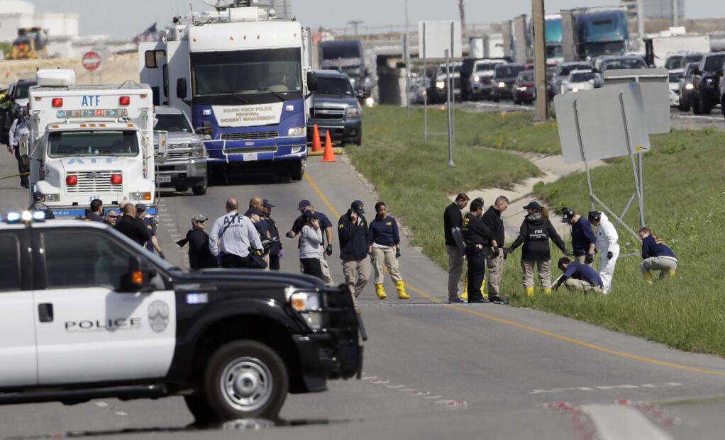 Officials continue to investigate the scene where a suspect in a series of bombing attacks in Austin blew himself up as authorities closed in, Wednesday, March 21, 2018, in Round Rock, Texas. (AP Photo/Eric Gay)