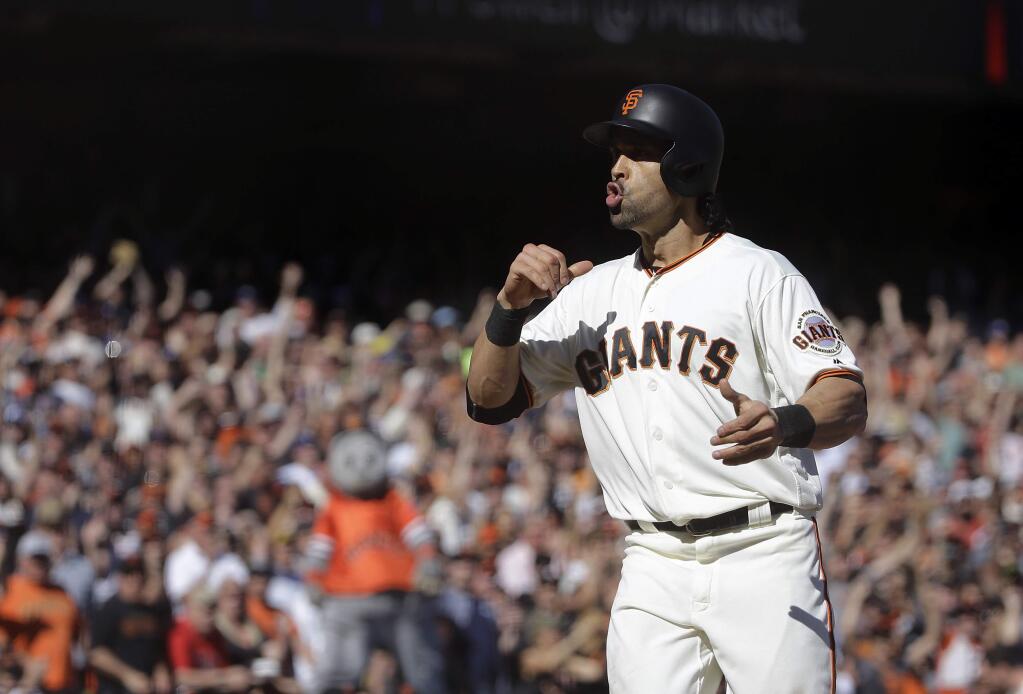 San Francisco Giants' Angel Pagan reacts after scoring against the Los Angeles Dodgers during the seventh inning of a baseball game in San Francisco, Saturday, Oct. 1, 2016. (AP Photo/Jeff Chiu)
