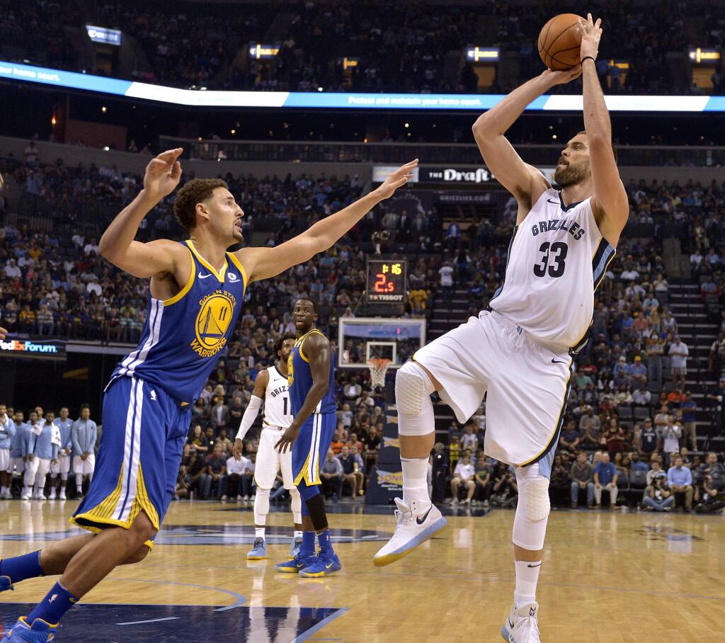 Memphis Grizzlies center Marc Gasol, right, shoots against Golden State Warriors guard Klay Thompson during the second half Saturday, Oct. 21, 2017, in Memphis, Tenn. (AP Photo/Brandon Dill)