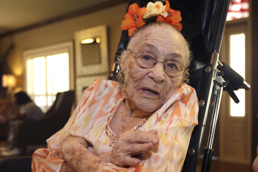 FILE - In this Thursday, July 3, 2014, file photo, Gertrude Weaver poses at Silver Oaks Health and Rehabilitation Center in Camden, Ark., a day before her 116th birthday. With the death of a 117-year-old woman in Japan, Weaver became the world's oldest person, according to the Los Angeles-based Gerontology Research Group, which tracks supercentenarians. (AP Photo/Danny Johnston, File)