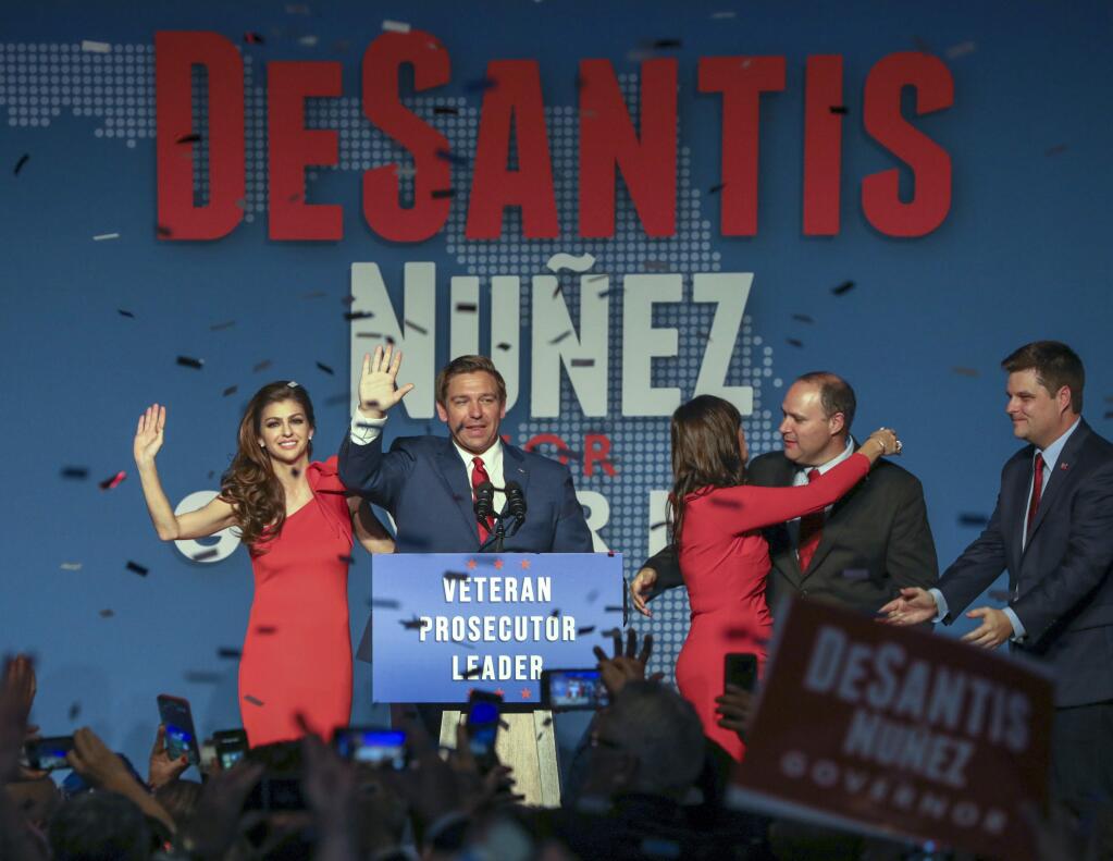 Republican Florida Governor-elect Ron DeSantis, center, waves to the supporters with his wife, Casey, left, and Republican Lt. Governor-elect Jeanette Nunez, third right, after thanking the crowd Tuesday, Nov. 6, 2018, in Orlando, Fla. DeSantis defeated Democratic candidate Andrew Gillum. (Chris Urso/Tampa Bay Times via AP)