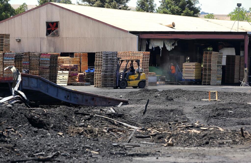 Wooden pallet manufacturing resumes at Sonoma Pacific Co. following Tuesday's fire, near the city of Sonoma on Thursday, June 7, 2018. (Christopher Chung/ The Press Democrat)