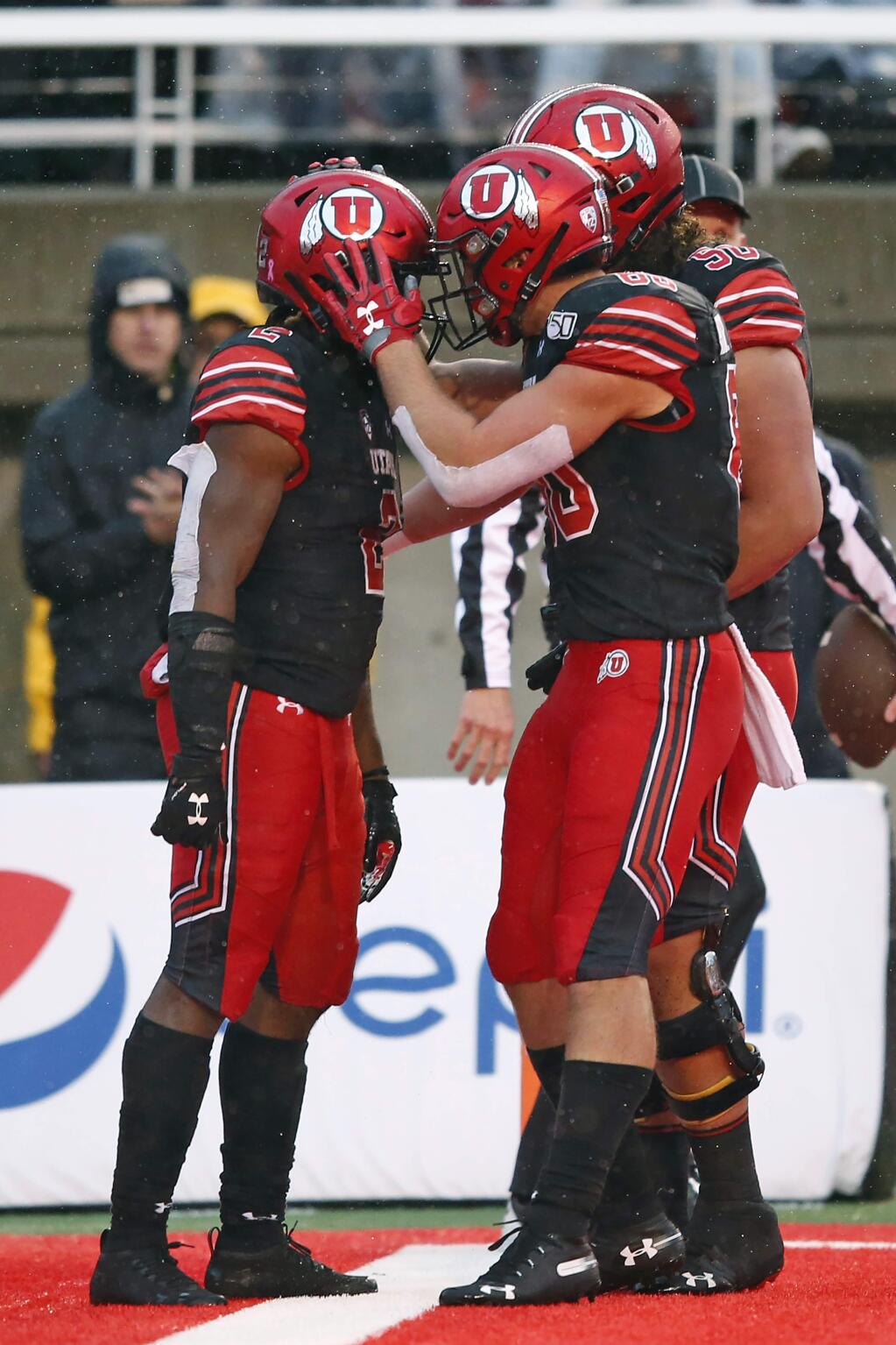 Utah running back Zack Moss, left, celebrates with teammates after his 1-yard touchdown run during the first half against Arizona State on Saturday, Oct. 19, 2019, in Salt Lake City. (AP Photo/Rick Bowmer)