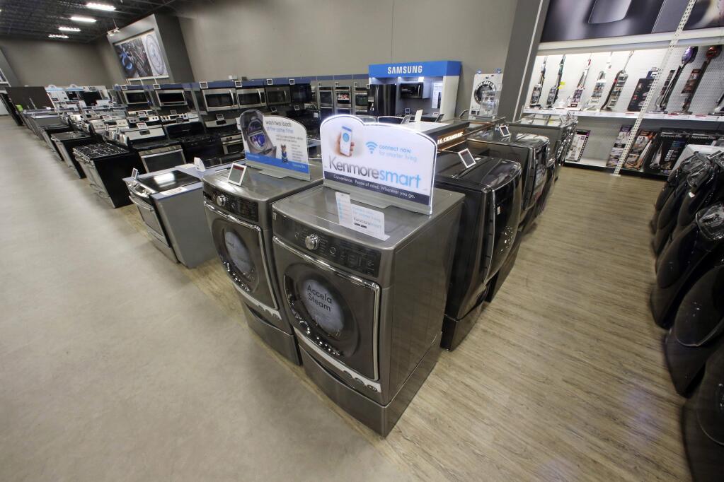 The Kenmore Elite Smart Electric Dryer and Front Load Washer, center, appears on display at a Sears store, Thursday, July 20, 2017, in West Jordan, Utah. Sears will begin selling its appliances on Amazon.com, including smart appliances that can be synced with Amazon's voice assistant, Alexa. Sears, which also owns Kmart, said that its Kenmore Smart appliances will be fully integrated with Amazon's Alexa, allowing users to control things like air conditioners through voice commands. (AP Photo/Rick Bowmer)