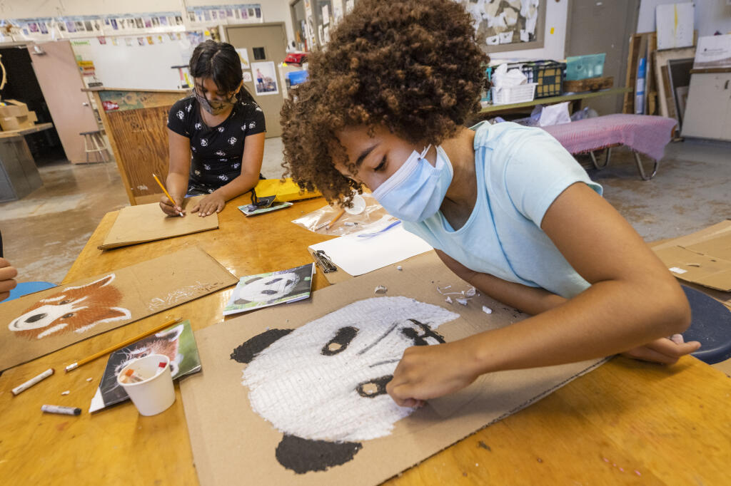 Maggie Balitbit, 10, right, and Brianna Jimenez, 11, learn to draw animal faces in their “Wild About Animals and Oil Pastels” class during the Excel for Youth program in conjunction with SSU on the Santa Rosa Middle School campus on Wednesday, July 15, 2021. (Photo by John Burgess/The Press Democrat)