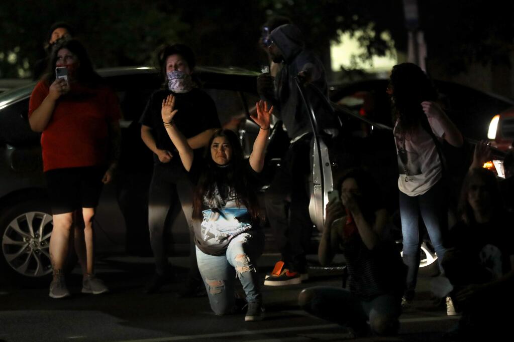 Protesters, surrounded by law enforcement from multiple agencies, wait to be arrested at the corner of Mendocino Ave. and Pacific Ave. in Santa Rosa, Calif., on Tuesday, June 2, 2020. (BETH SCHLANKER/ The Press Democrat)