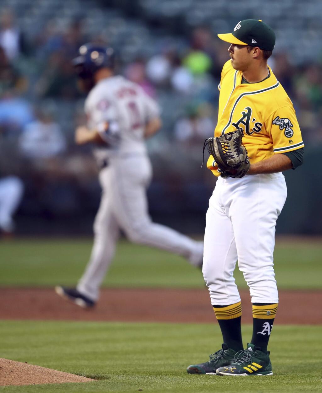 Oakland Athletics pitcher Daniel Mengden, right, waits for the Houston Astros' Evan Gattis to run the bases after hitting a three-run home run during the second inning Tuesday, June 12, 2018, in Oakland. (AP Photo/Ben Margot)