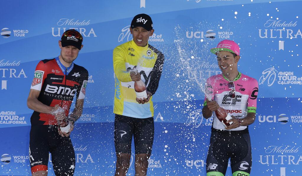 Bernal Gomez, center, winner of the Amgen Tour of California cycling race celebrates with second-place finisher Tejay van Garderen, left, and third-place finisher Daniel Martinez Saturday, May 19, 2018, in Sacramento, Calif. (AP Photo/Rich Pedroncelli)