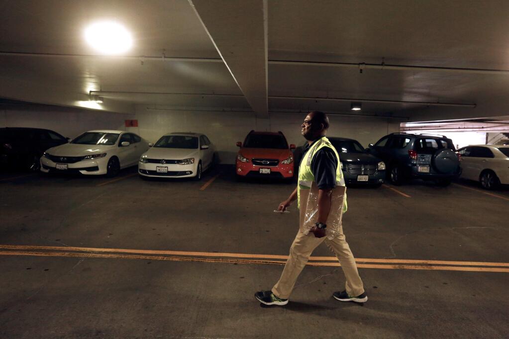 City of Santa Rosa parking operations aide Tony Lee makes one of his regular checks around garage 12 in downtown Santa Rosa, California, on Wednesday, November 14, 2018. The Santa Rosa City Council is set to establish two hours of free parking per night in five downtown garages from Black Friday to New Year's Eve. (Alvin Jornada / The Press Democrat)