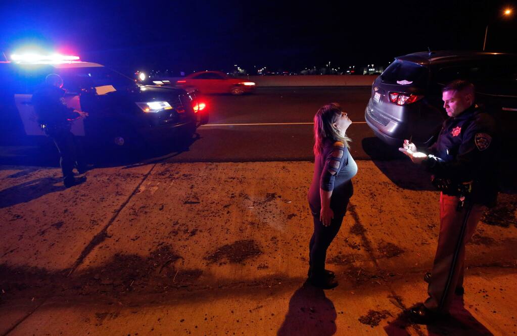 California Highway Patrol officer Josh Miller administers a field sobriety test.. (ALVIN JORNADA / The Press Democrat)