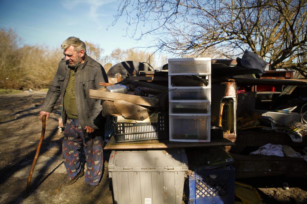 Petaluma, CA, USA. Monday, January 30, 2017._ Tony Sampson walks through his property on Liberty Road where Sonoma County officials said they have completed another extensive cleanup. Tony expressed disappointment that they left his desk and books outside where they were ruined by the recent rains. He also discovered trash thrown on his property that he says he was unaware of. (CRISSY PASCUAL/ARGUS-COURIER STAFF)
