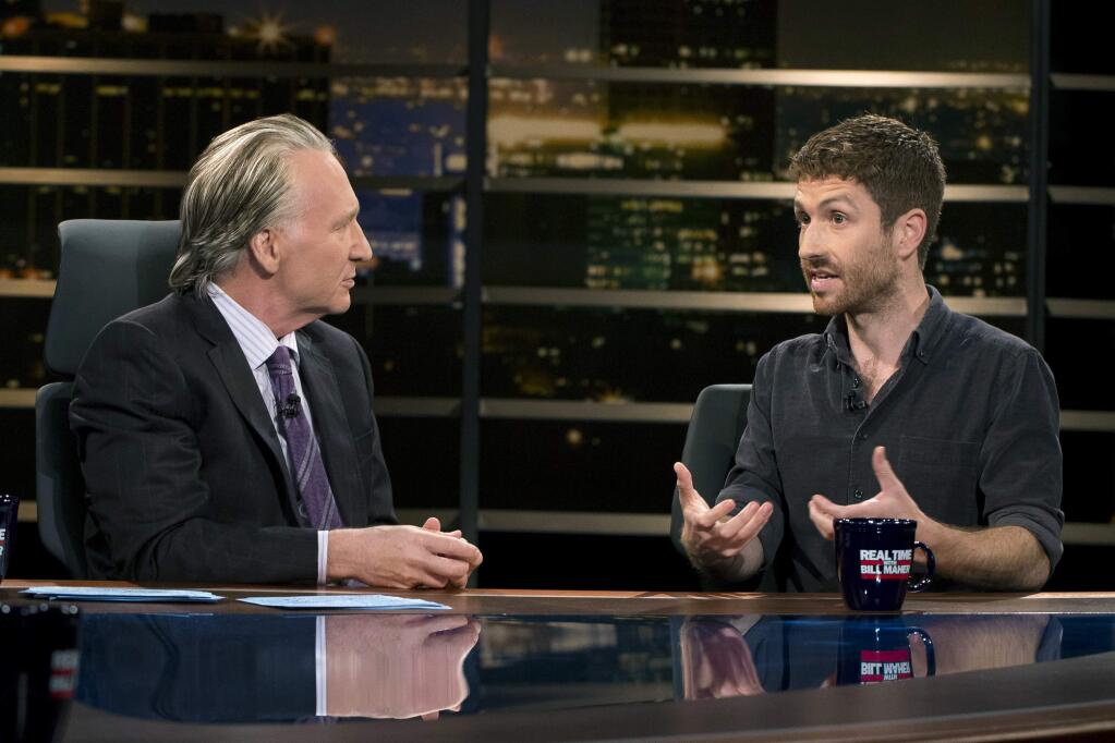 In this photo provided by HBO, Bill Maher, left, speaks with Tristan Harris, a co-founder of Time Well Spent, during a segment of his 'Real Time with Bill Maher,' Friday, June 2, 2017. (Janet Van Ham/HBO via AP)