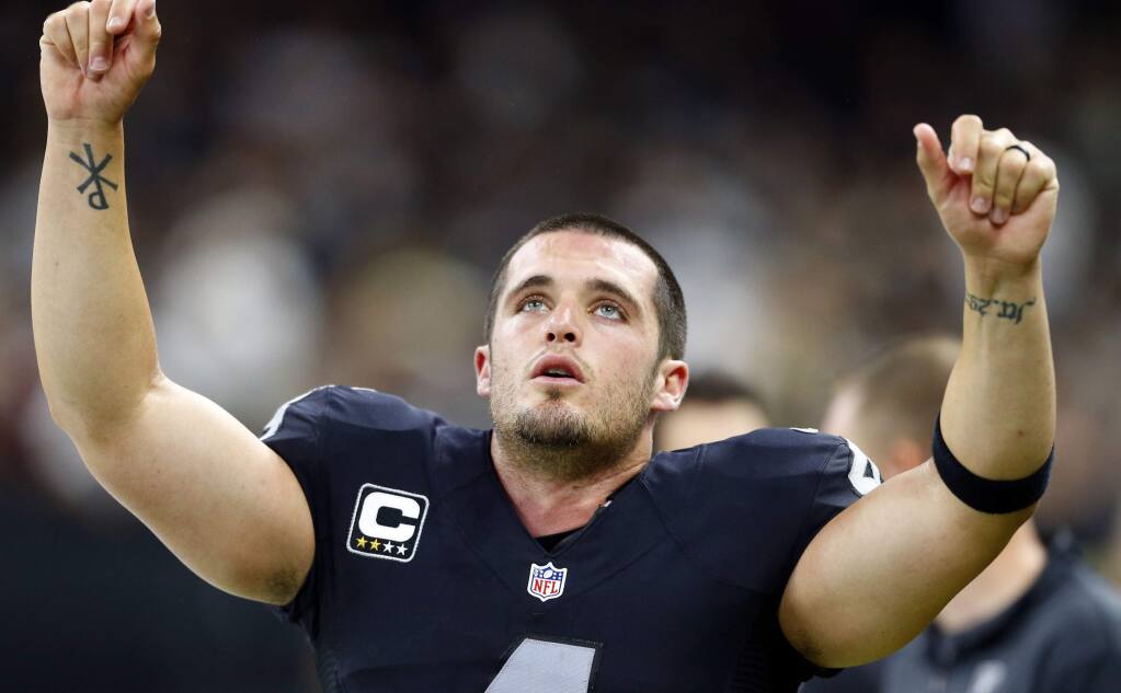 Oakland Raiders quarterback Derek Carr (4) reacts on the sideline in the second half of an NFL football game against the New Orleans Saints in New Orleans, Sunday, Sept. 11, 2016. (AP Photo/Butch Dill)