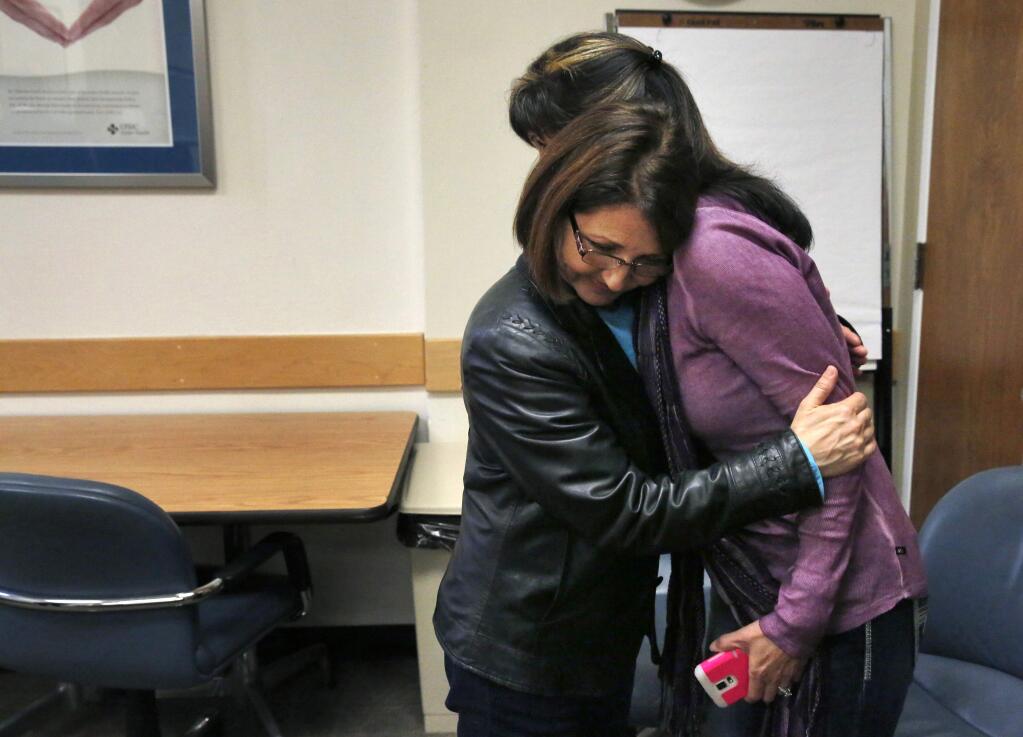 Kidney donor Zully Broussard, left, hugs her longtime friend Pam Nelson after a media conference at California Pacific Medical Center on Wednesday, March 4, 2015 in San Francisco. In a rare series of interlinked operations, six patients are getting kidney transplants from six donors at a San Francisco hospital. Dr. William Bry, a surgeon at California Pacific Medical Center, said the 'kidney paired donations' are occurring thanks to a woman who started a chain of donations and a computer program that matches donors to recipients. (AP Photo/San Francisco Chronicle, Leah Millis) MANDATORY CREDIT PHOTOG & CHRONICLE; MAGS OUT; NO SALES