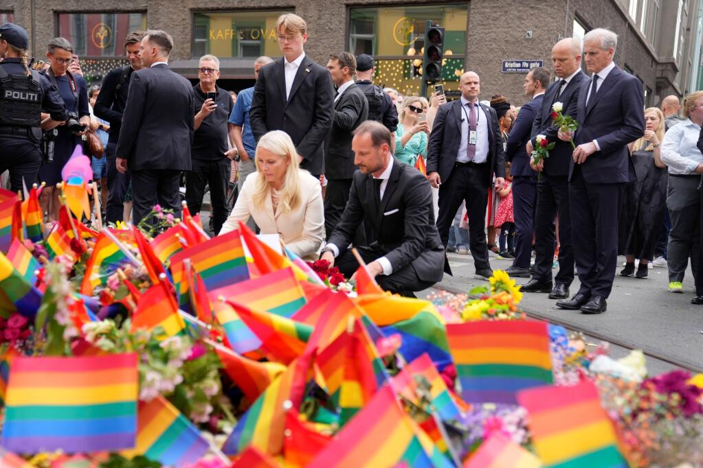 Norway's Crown Prince Haakon, Crown Princess Mette-Marit and Prime Minister Jonas Gahr Stoere, right, visit the scene of a shooting in central Oslo, Norway, Saturday, June 25, 2022. Norwegian police say they are investigating an overnight shooting in Oslo that killed two people and injured more than a dozen as a case of possible terrorism. In a news conference Saturday, police officials said the man arrested after the shooting was a Norwegian citizen of Iranian origin who was previously known to police but not for major crimes. (Javad Parsa/NTB via AP)