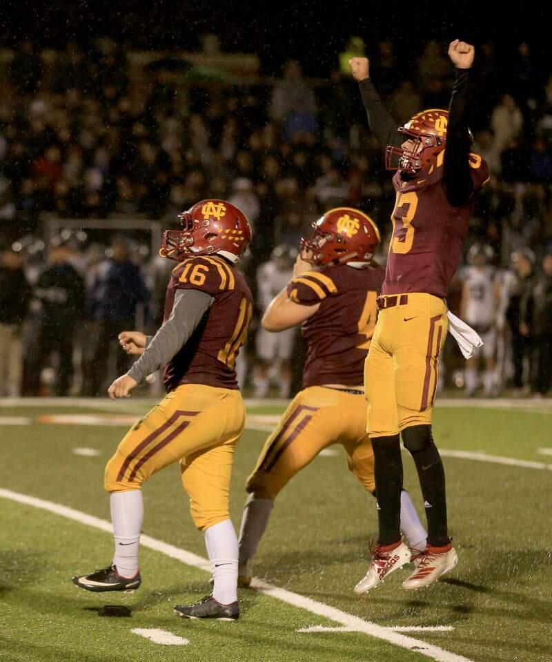 KENT PORTER/THE PRESS DEMOCRATEthan Kollenborn (16) watches his game-winning field goal sail through the uprights as John Headley, right, and Shane Moran celebrate as Cardinal Newman beats Marin Catholic 13-10 to win the NCS championship.