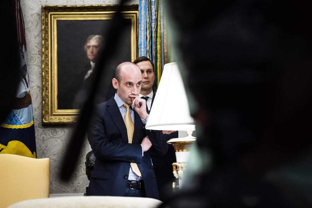 White House advisers Stephen Miller, left, and Jared Kushner listen as President Donald Trump speaks in the Oval Office as Guatemala signs a “safe third country” agreement to restrict asylum applications to the U.S. from Central America in July. MUST CREDIT: Washington Post photo by Jabin Botsford.