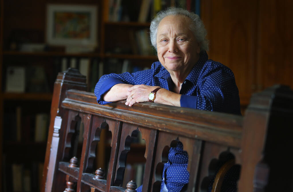 Gaye LeBaron poses with a bannister from a historic Fountaingrove home that belonged to Thomas Lake Harris. (Christopher Chung / The Press Democrat file)