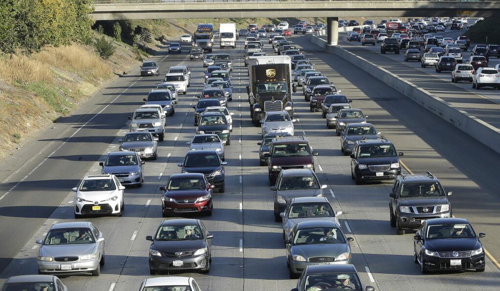 FILE - In this Monday, Oct. 30, 2017, file photo, vehicles crowd Highway 50 in Sacramento, Calif. As the political battle to overturn California's gas tax increase intensified the state transportation agency coordinated frequently with the public relations firm working to block the repeal on behalf of unions, construction companies and local governments, emails obtained by The Associated Press show. (AP Photo/Rich Pedroncelli, File)