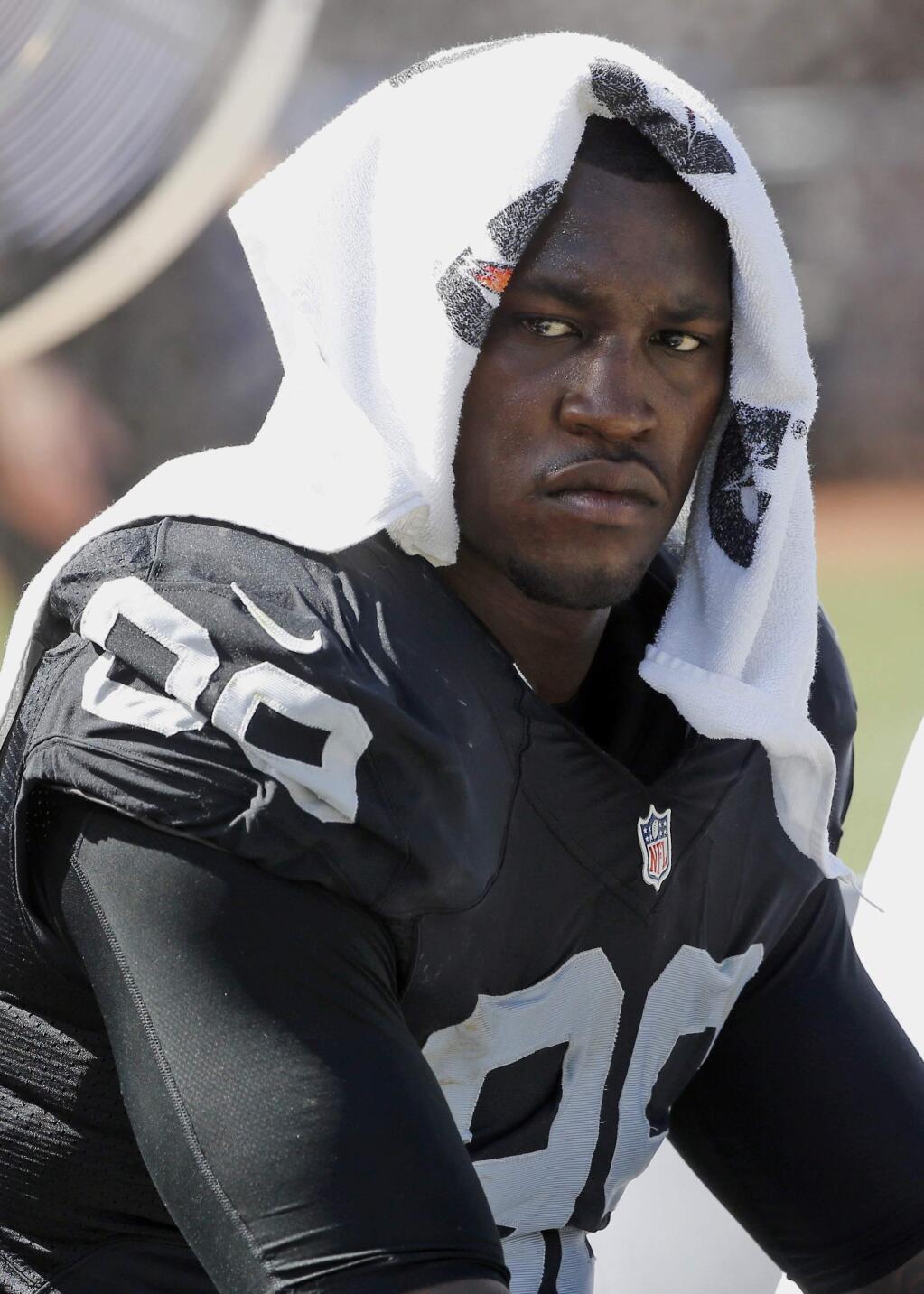 FILE - In this Sept. 20, 2015, file photo, Oakland Raiders' Aldon Smith cools off during an NFL football game against the Baltimore Ravens in Oakland , Calif. The former Raiders player turned himself into police on Tuesday, March 6, 2018, and was booked into San Francisco County Jail on suspicion of misdemeanor domestic violence and three related misdemeanors. (AP Photo/Tony Avelar, File)