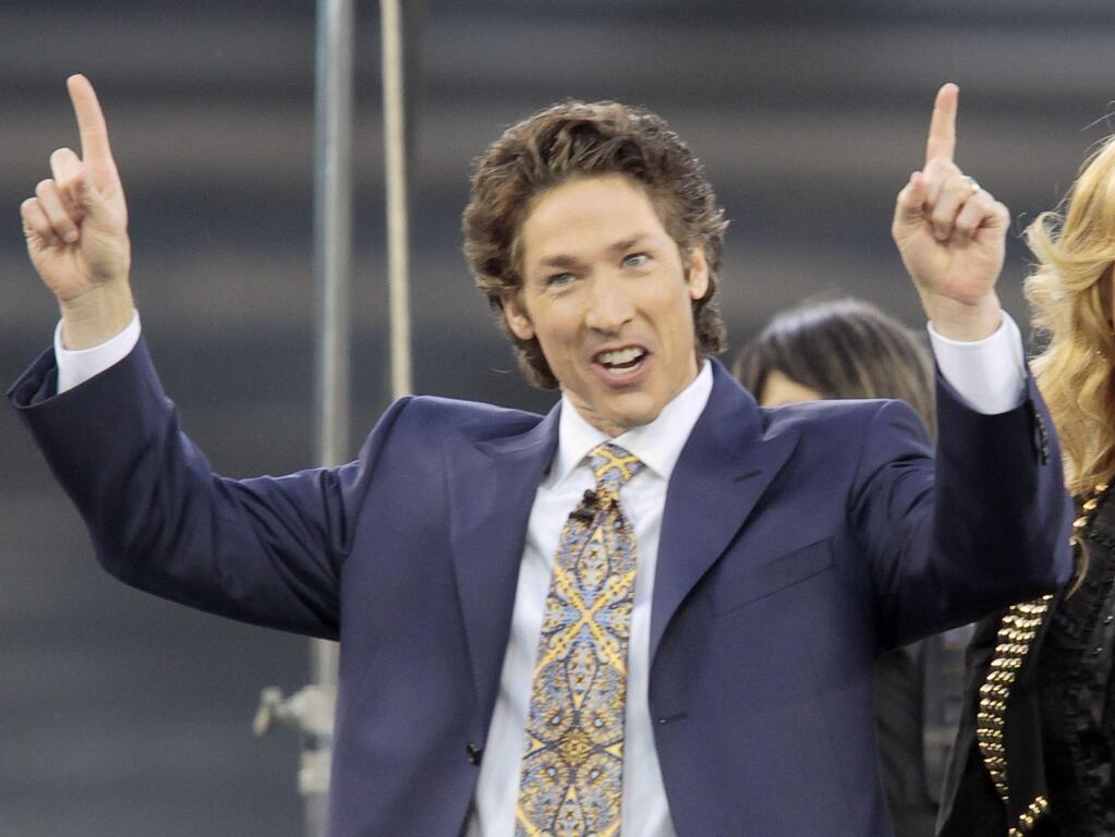 FILE - This April 24, 2010 file photo shows Lakewood Church pastor Joel Osteen at Dodger Stadium during his 'A Night of Hope' in Los Angeles. Osteen said in a statement to ABC News on Aug. 28, 2017, that his Lakewood Church would open as a shelter for Hurricane Harvey victims if needed. (AP Photo/Richard Vogel, File)