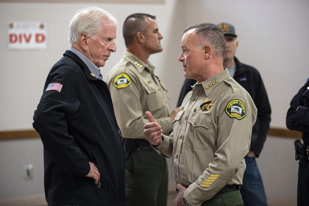 Sonoma County Sheriff Mark Essick talks with Rep. Mike Thompson before the Monday evening press conference updating information on the Kincade fire. (photo by John Burgess/The Press Democrat)