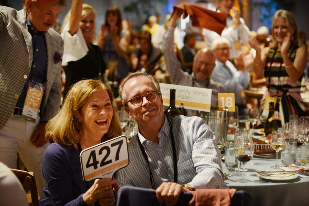 Pamela Hamel, left, and George Hamel, Jr., of Hamel Family Wines celebrate after a winning bid at the Sonoma County Wine Auction in 2017. George Hamel, Jr., will serve as an Alumni Honorary Chair for this year’s Sonoma County Wine Auction on Sept. 16-18. (Erik Castro/for The Press Democrat)
