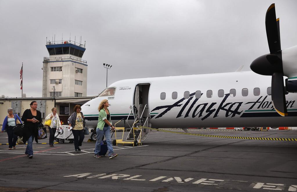 Passengers board their Alaska Airlines flight bound for Los Angeles, at the Charles M. Schulz-Sonoma County Airport, in Santa Rosa, on Friday, Aug. 21, 2015. (Christopher Chung/ The Press Democrat)