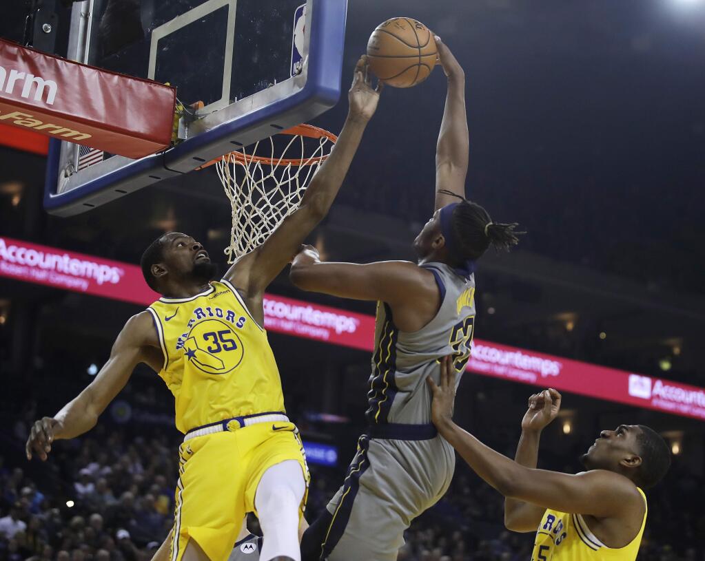The Golden State Warriors' Kevin Durant, left, blocks a shot from the Indiana Pacers' Myles Turner during the first half Thursday, March 21, 2019, in Oakland. (AP Photo/Ben Margot)