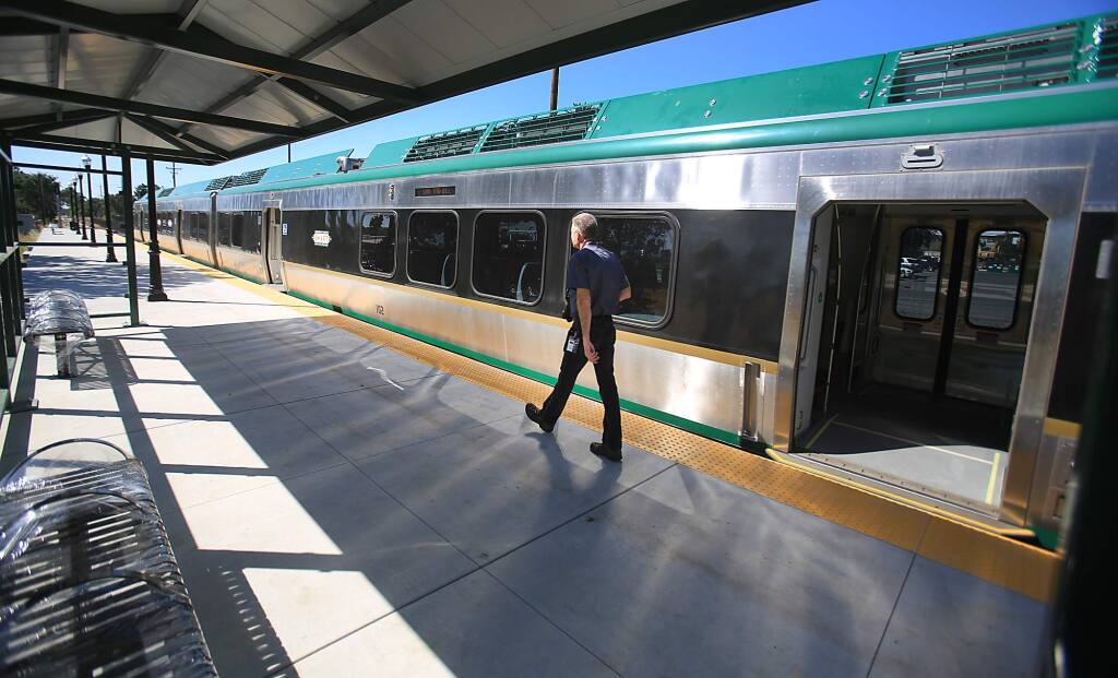 Matt Stevens, SMART's community education and outreach employee, uses the new Airport Blvd. station to take photos of a SMART railcar, Wednesday June 29, 2016 in Santa Rosa. (Kent Porter / Press Democrat) 2016