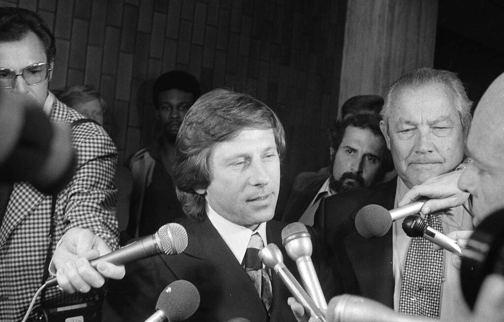FILE-This undated file photo shows Polish-born film director Roman Polanski talking to the media in Los Angeles. A Los Angeles judge on Tuesday, Dec. 23, 2014, denied a bid by the Oscar-winning director's lawyers for a hearing that could lead to the dismissal of a 1977 unlawful sex with a minor case. (AP Photo, File)