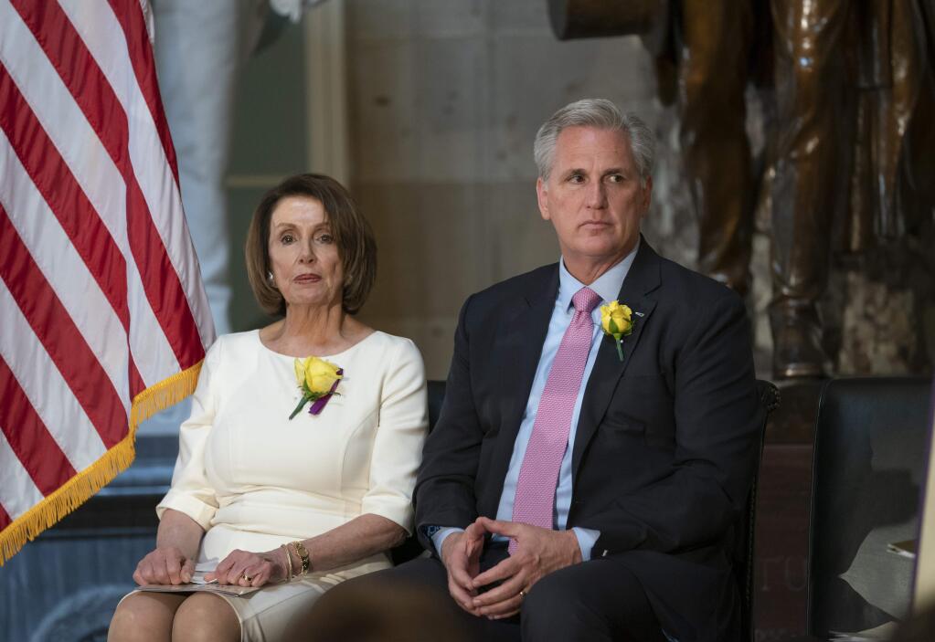 Speaker of the House Nancy Pelosi, D-Calif., and House Republican Leader Kevin McCarthy, D-Calif., right, sit together at an event to commemorate the 100th anniversary of House passage of the 19th Amendment, which gave women the right to vote, at the Capitol in Washington, Tuesday, May 21, 2019. More Democrats in Pelosi's caucus are calling for impeachment proceedings against President Donald Trump after his latest defiance of Congress by blocking his former White House lawyer from testifying on Tuesday. (AP Photo/J. Scott Applewhite)