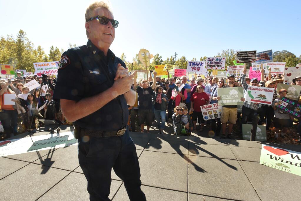 “I can't even talk; this is overwhelming,” said Sonoma County Fire Deputy Chief Matt Gustafson as he received a warm welcome from a large gathering of local residents at the Windsor Town Green on Nov. 3, 2019. (Erik Castro/ for The Press Democrat)