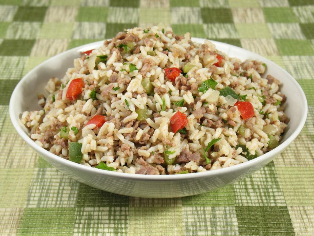 Dirty rice, a classic Cajun dish, is delicious with roasted or fried chicken, grilled sausages, pork chops and such. It also is excellent topped with boiled crawfish or with Gulf shrimp.