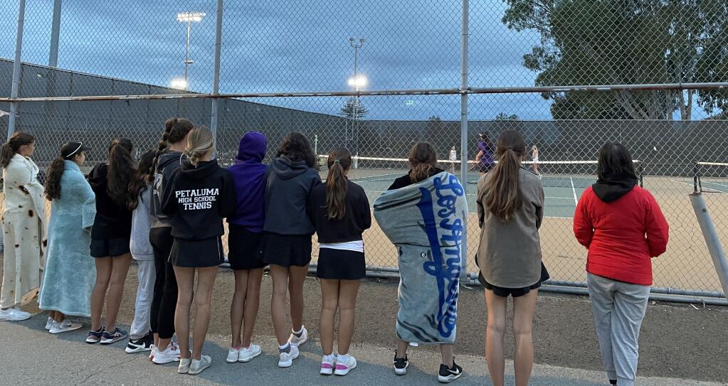 Petaluma tennis team members watch as teammates Daphne Perlich and Audree Looper play decisive match against Vintage. (SUBMITTED PHOTO)