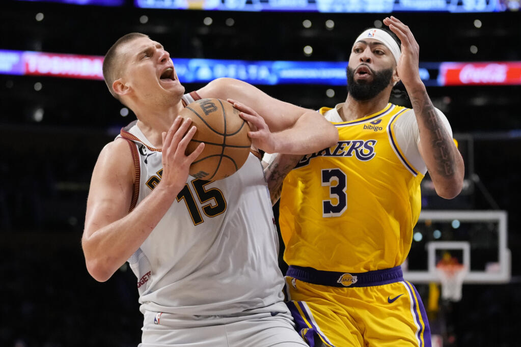 Denver Nuggets center Nikola Jokic is defended by Lakers forward Anthony Davis in the second half of Game 4 of the NBA Western Conference Final series Monday, May 22, 2023, in Los Angeles. (Ashley Landis / ASSOCIATED PRESS)