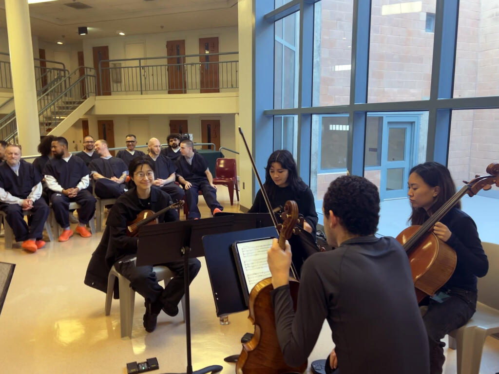 The Edith String Quartet, composed of four Juilliard students playing two violins, a cello and viola, prepares Monday, Jan. 29, 2024, to play for 11 men in the music composition course and about 60 Sonoma County residents in the Sonoma County Main Adult Detention Facility. (Sonoma County Sheriff’s Office)