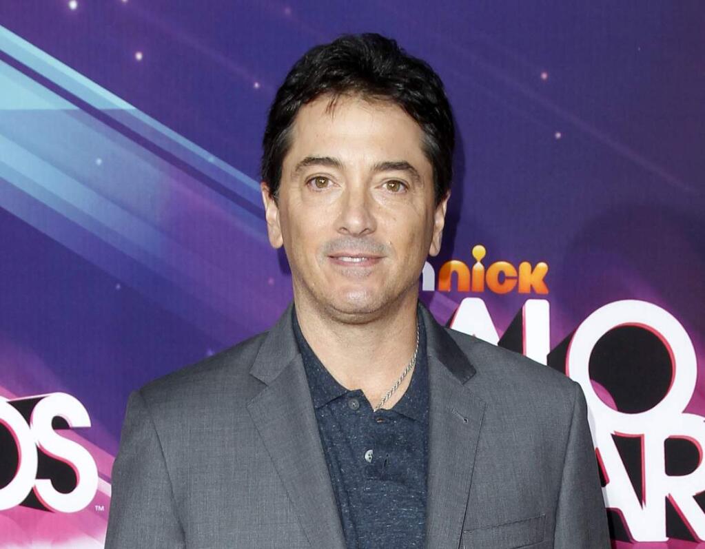 FILE - In this Nov. 17, 2012 file photo, actor Scott Baio arrives at the TeenNick HALO Awards in Los Angeles. Former “Charles in Charge” actor Alexander Polinsky says Baio assaulted and “mentally tortured” him during their time together on the show in the 1980s. Polinsky made the allegations Wednesday, Feb. 14, 2018, in Los Angeles during a news conference called by his attorney. (Photo by Joe Kohen/Invision/AP, File)
