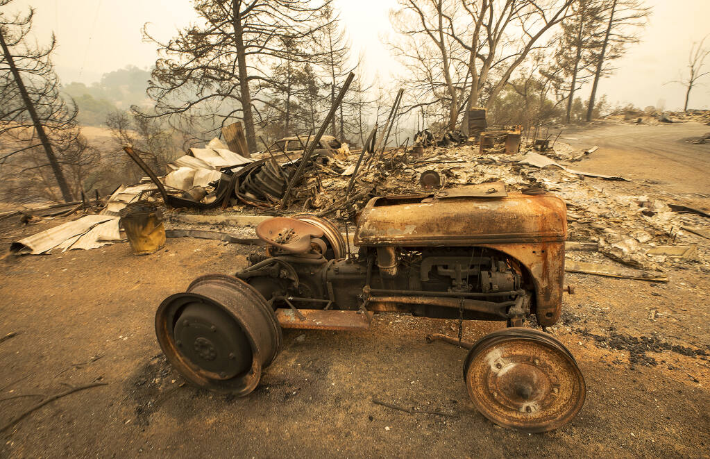 An old tractor rests on the site of a home razed by the Glass Fire on Los Alamos Rd.on Friday, October 2, 2020. (Photo by John Burgess/The Press Democrat)