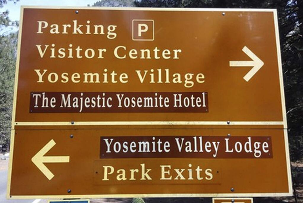 A traffic sign directs Yosemite visitors to the renamed Ahwahnee Hotel and Yosemite Lodge. Their traditional names were restored this week following a lawsuit settlement. (RORY APPLETON / Fresno Bee, 2016)